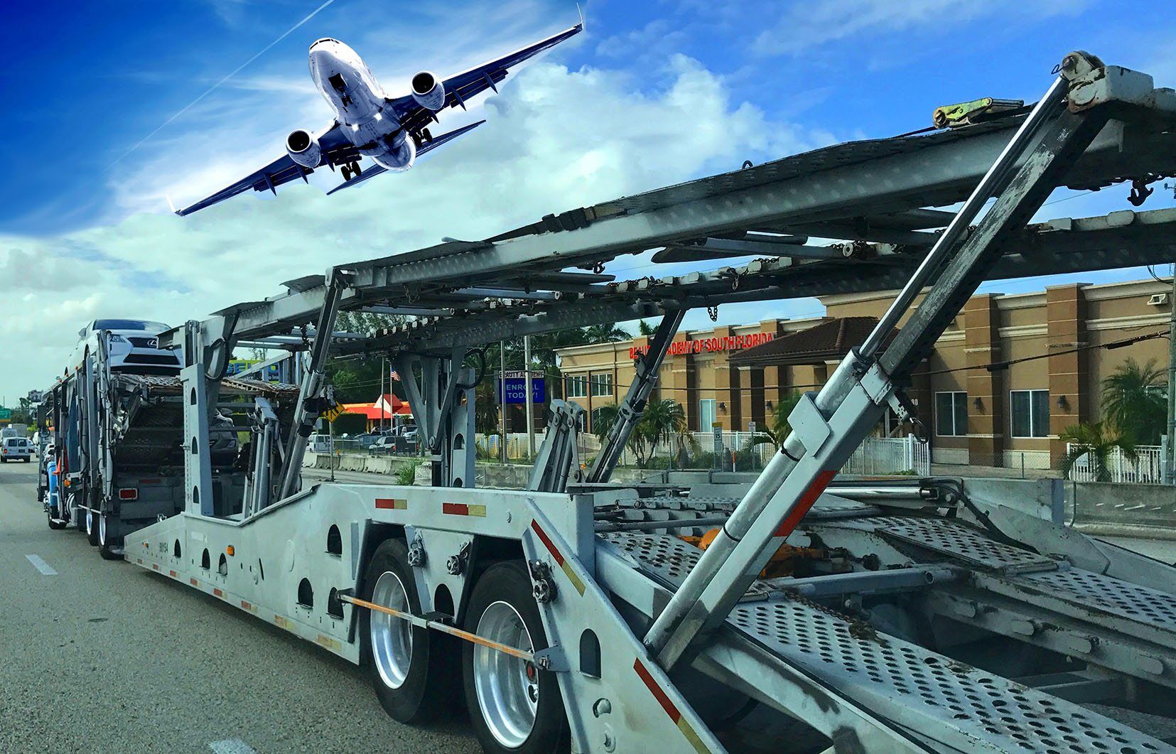 plane overhead above auto shipping car carrier